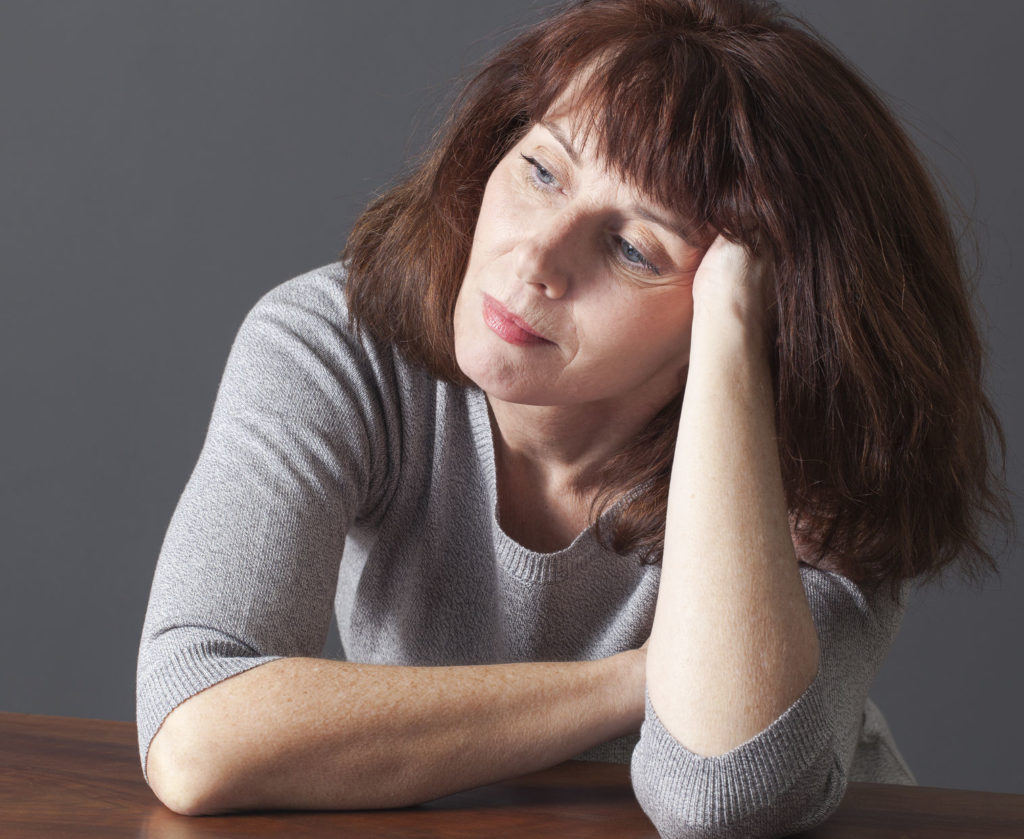 Senior Woman Resting Her Face on Her Hands Image