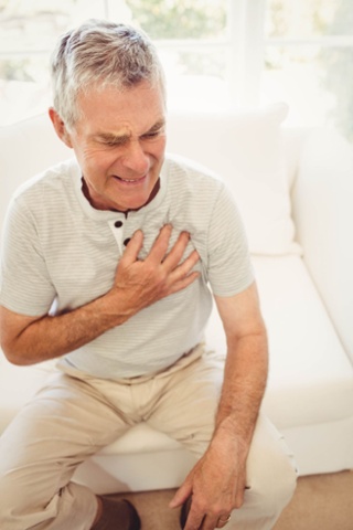 Man Holding Hand over Chest Image