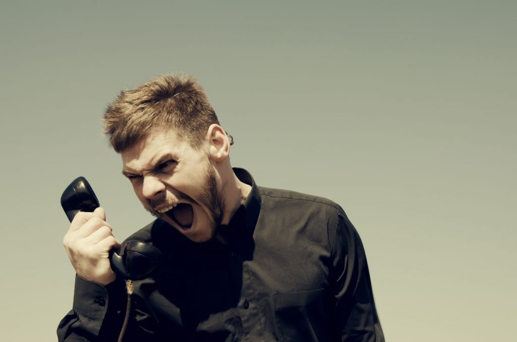 Extremely Angry Man Shouting at the Phone Image