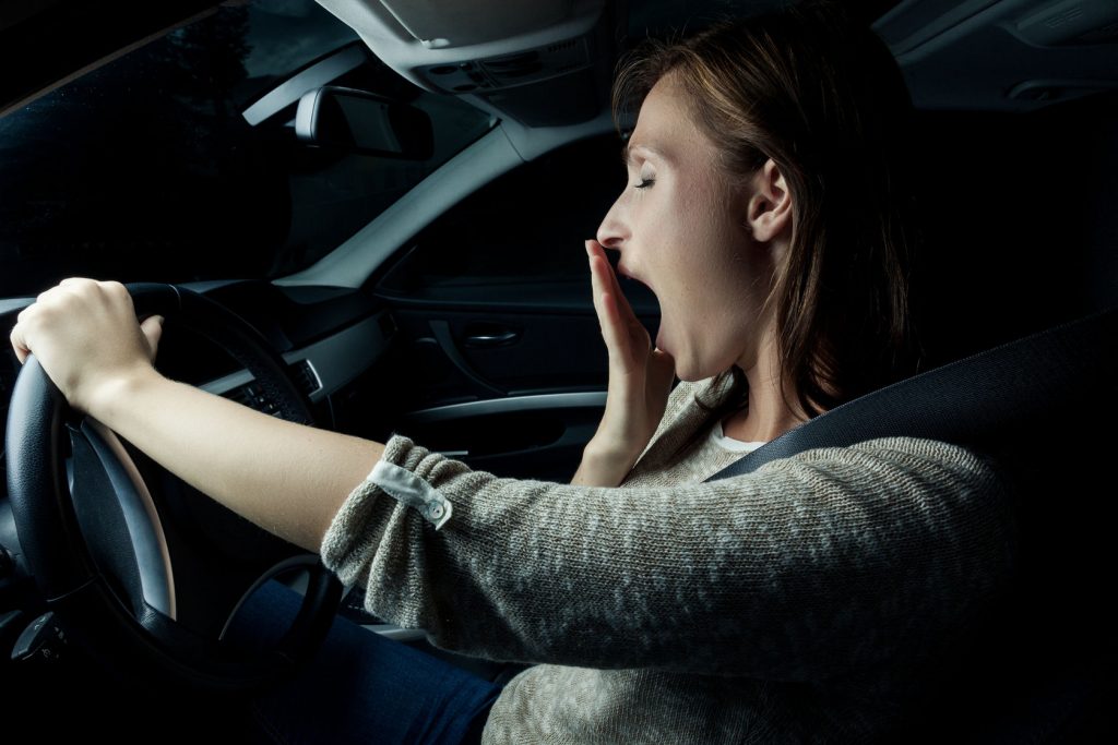 Lady Yawning Driving Vehicle Image